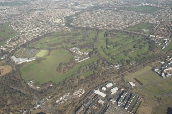 Oblique aerial view of Duddingston House and golf course and Holyrood Roman Catholic Secondary School, looking to the NNE.