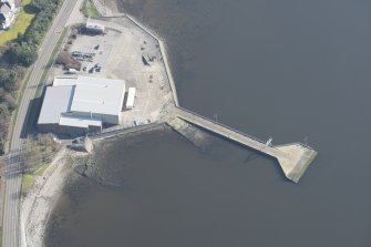 Oblique aerial view of former seaplane base, looking E.