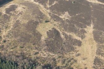 Oblique aerial view of the site of enclosure, pillboxes and trenches, looking W.