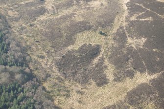 Oblique aerial view of the site of enclosure, pillboxes and trenches, looking SW.