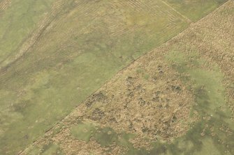 Oblique aerial view of the site of pillboxes and trenches, looking N.