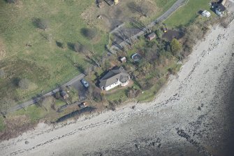 Oblique aerial view of the searchlight battery showing the W most being incorporated into a current house and the E position still complete, looking NNE.