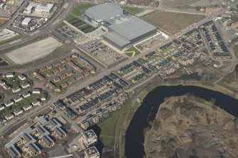 Oblique aerial view of of the Glasgow Commonwealth Games site including the athlete's village and Sir Chris Hoy Velodrome, looking to the NW.