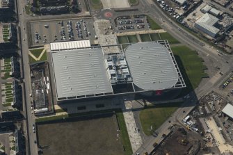 Oblique aerial view of of the Sir Chris Hoy Velodrome, looking to the SW.