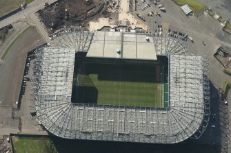 Oblique aerial view of of Parkhead football stadium, looking to the SW.