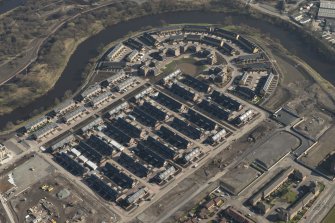 Oblique aerial view of of the Glasgow Commonwealth Games site including the athlete's village, looking to the ESE.