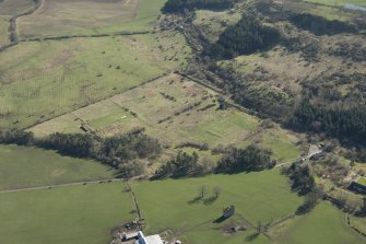 Oblique aerial view of part of the Dechmont Rifle Ranges and Gilbertfield Castle, looking ESE.