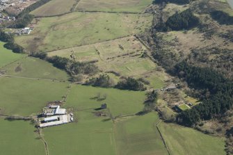 Oblique aerial view of part of the Dechmont Rifle Ranges and Gilbertfield Castle, looking E.