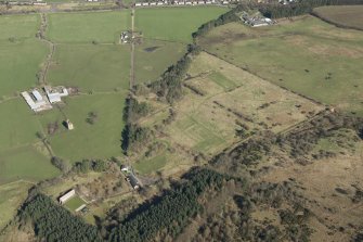 Oblique aerial view of part of the Dechmont Rifle Ranges and Gilbertfield Castle, looking N.