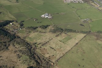 Oblique aerial view of part of the Dechmont Rifle Ranges and Gilbertfield Castle, looking WNW.