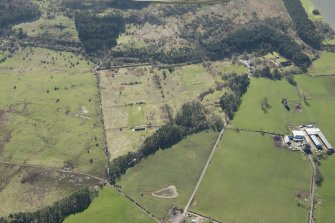 Oblique aerial view of part of the Dechmont Rifle Ranges and Gilbertfield Castle, looking SSE.