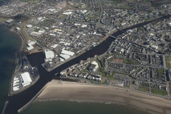 Oblique aerial view of Ayr and main harbour, looking E.