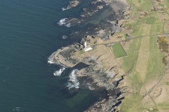 Oblique aerial view of Turnberry Castle and Turnberry Lighthouse, looking NE.