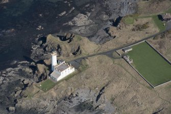 Oblique aerial view of Turnberry Castle and Turnberry Lighthouse, looking NE.