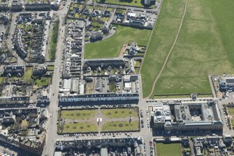 Oblique aerial view of Wellington Square, County Buildings and Prison, looking S.