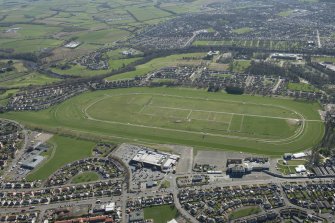 Oblique aerial view of Ayr Airfield and Ayr Racecourse, looking N.