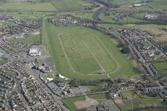 Oblique aerial view of Ayr Airfield and Ayr Racecourse, looking W.