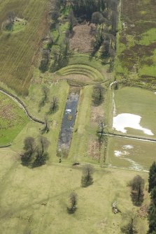Oblique aerial view of the formal gardens and pond at Carmichael House, looking SSE.