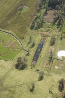 Oblique aerial view of the formal gardens and pond at Carmichael House, looking SE.