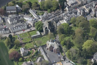 Oblique aerial view of Kelso Abbey and War Memorial, looking W.