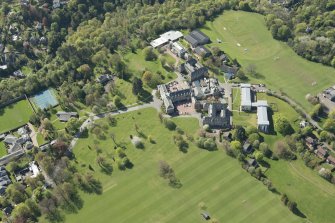 Oblique aerial view of Colinton Castle and Merchiston Castle School, looking W.