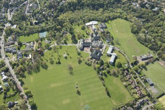 Oblique aerial view of Colinton Castle and Merchiston Castle School, looking WSW.