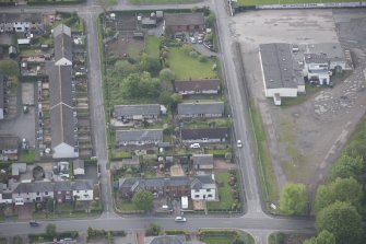 Oblique aerial view of five long rectangular single story timber  houses, looking S.