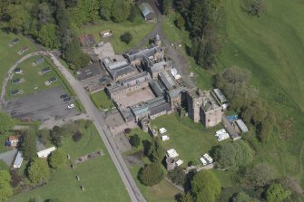 Oblique aerial view of Hoddom Castle, looking NNW.