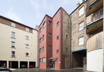 View of rear elevation of 124 Canongate, Edinburgh, from SE.