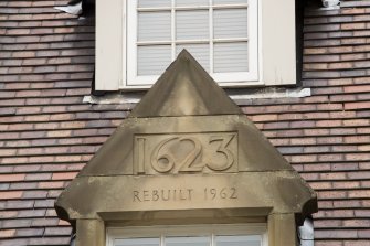 Detail of datestone in pediment '1623 REBUILT 1962' at 1-12 White Horse Close, 29 Canongate, Edinburgh.