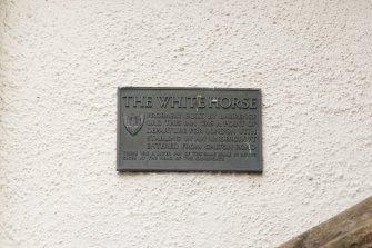 Detail of plaque giving history of 1-12 White Horse Close, 29 Canongate, Edinburgh.