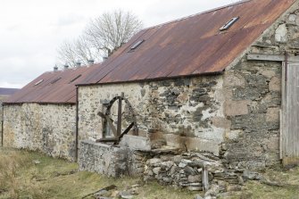 South end of steading with mill wheel, view from south west