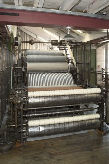 Interior. Main mill building, view of Intermediate Carding Machine. After wool soaked to remove dirt and grease, oiled in thenscribbler to make it easier to work with, it is put through rough, intermediate and fine carding prior to spinning