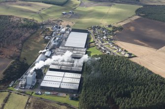 Oblique aerial view of the Glenlossie and Mannochmore Distilleries, looking SW.