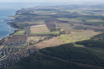 General oblique aerial view of the coastline with Burghead transmitter station and Cummingstown in the foreground and Hopeman village in the distance, looking ENE.