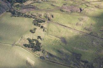 Oblique aerial view of the remains of the farmstead, looking ESE.