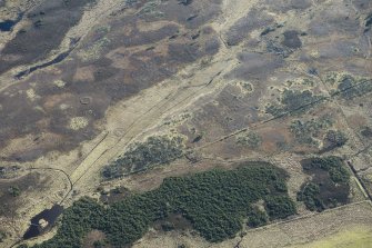 Oblique aerial view of hut circles at Big Burn near Balvonie of Leys, looking SE.