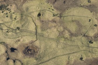 Oblique aerial view of hut circles and rig at Achvraid, looking E.
