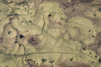 Oblique aerial view of hut circles and rig at Achvraid, looking E.