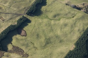 Oblique aerial view of a hut circle, field system and rig at Achvraid, looking w.