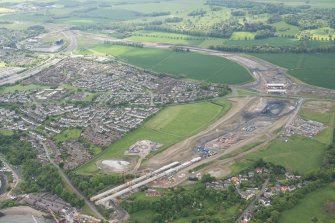 Oblique aerial view of the roadworks for the new Queensferry Crossing on the south bank of the Forth, looking NW.