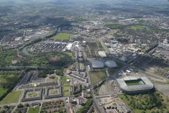 Oblique aerial view of the Commonwealth Games Village, Celtic Park and Emirates Arena, looking SW.