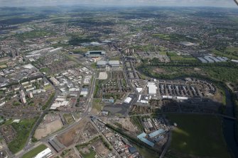 Oblique aerial view of the Commonwealth Games Village, Celtic Park and Emirates Arena, looking NE.