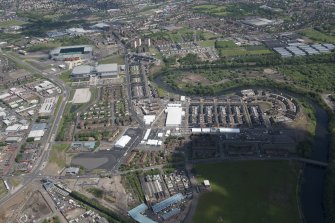 Oblique aerial view of the Commonwealth Games Village, Celtic Park and Emirates Arena, looking NNE.