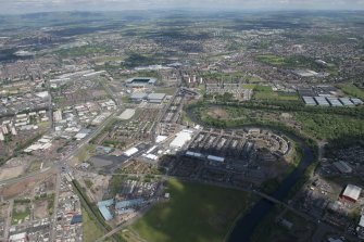 Oblique aerial view of the Commonwealth Games Village, Celtic Park and Emirates Arena, looking NNE.