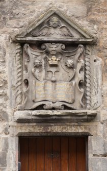 Detail of decorative panel above doorway at 185 Canongate (Bible Land), Edinburgh.