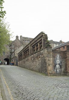 View of remnants of boundary wall of former Gas Works, Old Tolbooth Wynd, Edinburgh, from N.