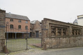 General view of former boundary wall and buildings of former Gas Works, Old Tolbooth Wynd, Edinburgh, from SE.