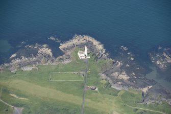 Oblique aerial view of Turnberry Lighthouse and Turnberry  Castle, looking NW.