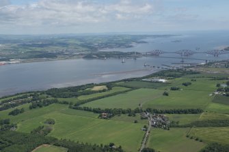 General oblique aerial view of the Upper Firth of Forth with The Queensferry Crossing construction, The Forth Road bridge and Forth bridge in the distance and the village of Newton in the foreground, looking NE.